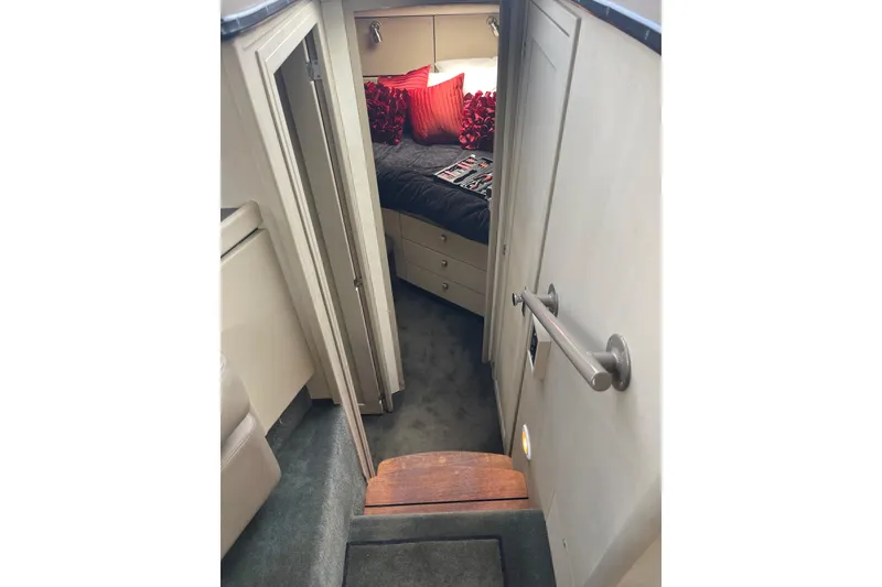 Slide: The Image of Interior cabin view of a 1996 Bayliner 3255 Avanti with cozy bedding and modern decor. - 26