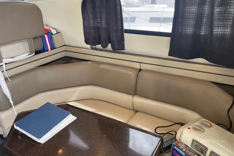 Slide: The Image of Interior of 1996 Bayliner 3255 Avanti boat with beige seating and table. - 27