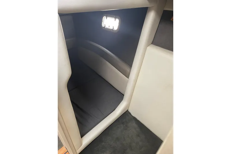 Slide: The Image of Interior cabin of 1996 Bayliner 3255 Avanti boat with window and seating area. - 28