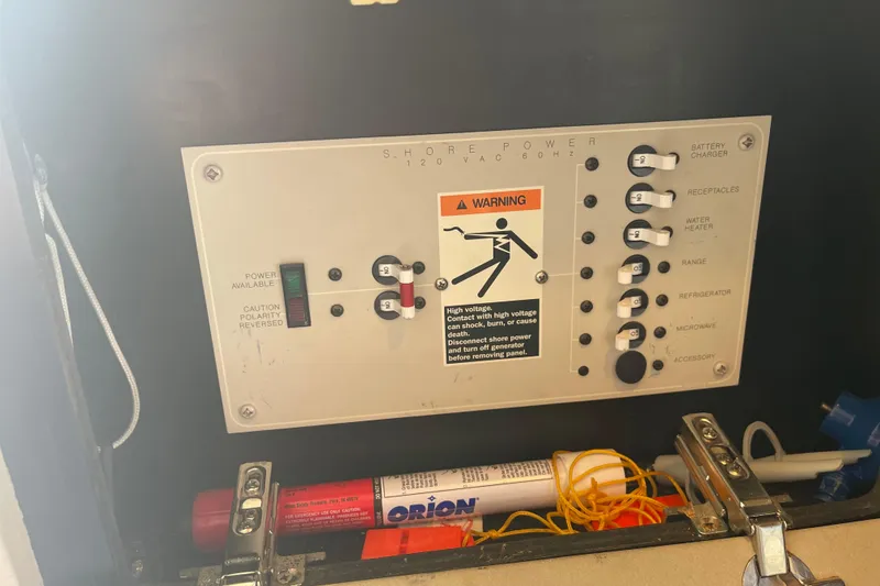 Slide: The Image of Electrical panel on a 1996 Bayliner 3255 Avanti boat with safety warning. - 32