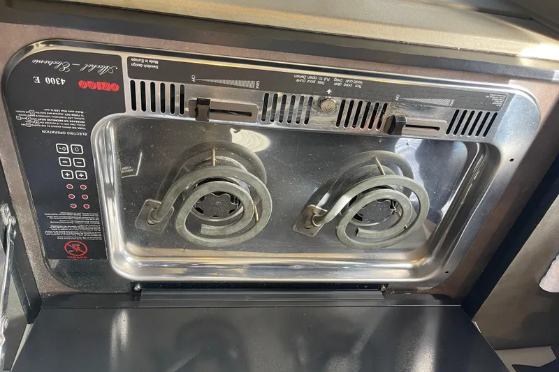 Slide: The Image of Electric stove in a 1996 Bayliner 3255 Avanti boat kitchen area. - 34