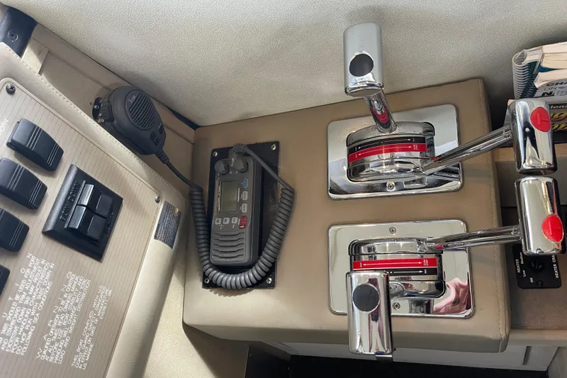 Slide: The Image of Control panel of a 1996 Bayliner 3255 Avanti boat with throttle levers and radio. - 38