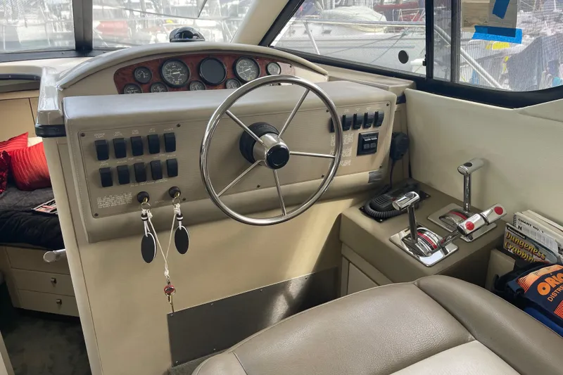 Slide: The Image of 1996 Bayliner 3255 Avanti boat cockpit with steering wheel and control panel. - 40