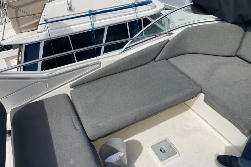Slide: The Image of 1996 Bayliner 3255 Avanti boat interior with gray seating and deck view. - 7