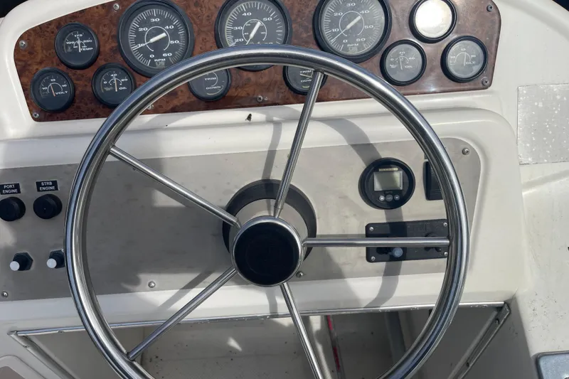 Slide: The Image of 1996 Bayliner 3255 Avanti boat dashboard with steering wheel and gauges. - 9