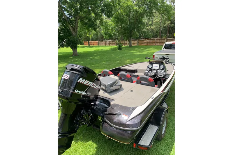 Slide: The Image of 2010 Nitro Z-7 boat with Mercury engine, parked on grass. - 7