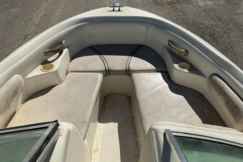 Slide: The Image of 1998 Sea Ray 175 Bow Rider interior with seating and cup holders. - 10