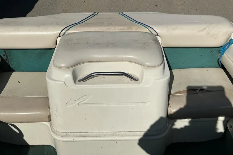 Slide: The Image of 1998 Sea Ray 175 Bow Rider boat seating area with storage compartment and handle. - 11