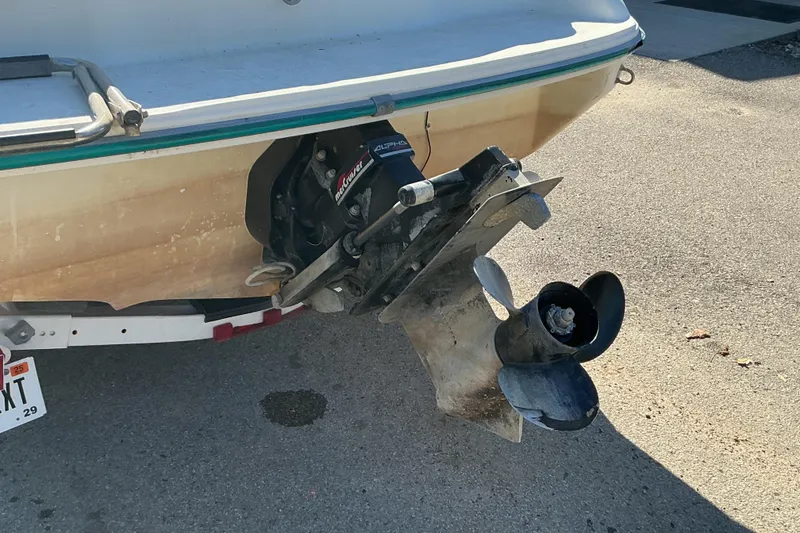 Slide: The Image of 1998 Sea Ray 175 Bow Rider boat with visible propeller and outdrive on a trailer. - 13