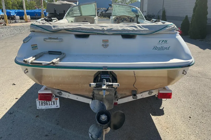 Slide: The Image of 1998 Sea Ray 175 Bow Rider boat, rear view, parked outdoors. - 4