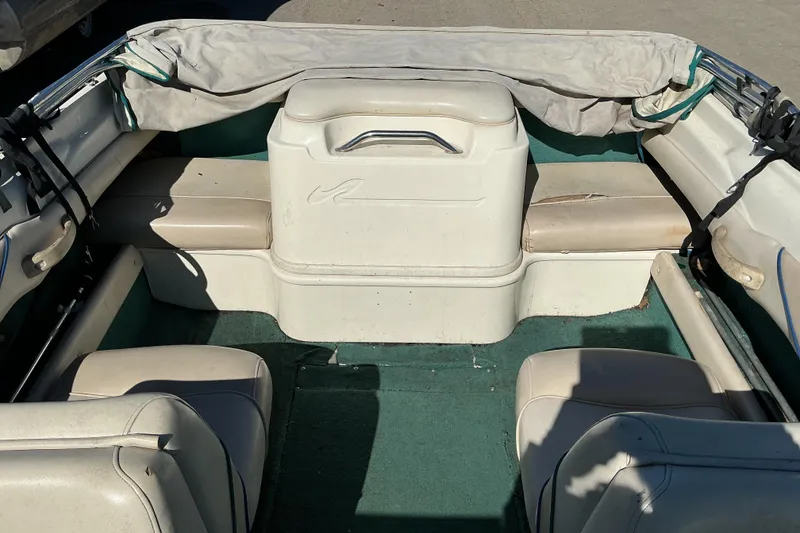 Slide: The Image of 1998 Sea Ray 175 Bow Rider interior with white seating and green carpet. - 6