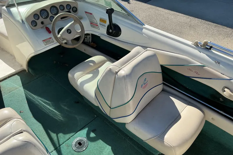 Slide: The Image of 1998 Sea Ray 175 Bow Rider interior with steering wheel and seating. - 7