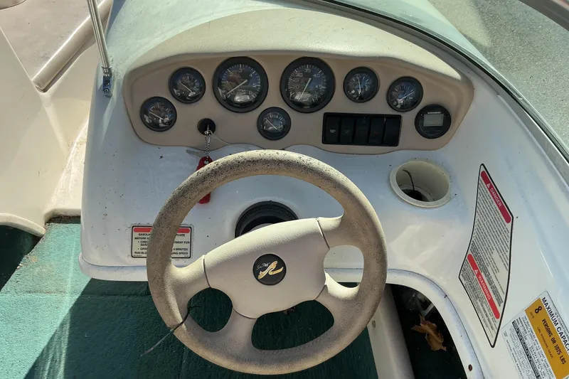 Slide: The Image of 1998 Sea Ray 175 Bow Rider dashboard with steering wheel and instrument panel. - 9