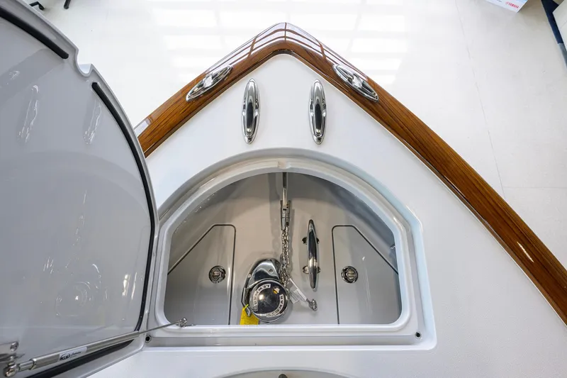 Slide: The Image of 2026 Valhalla Boatworks V-37 anchor compartment with polished wood trim and stainless steel fittings. - 11