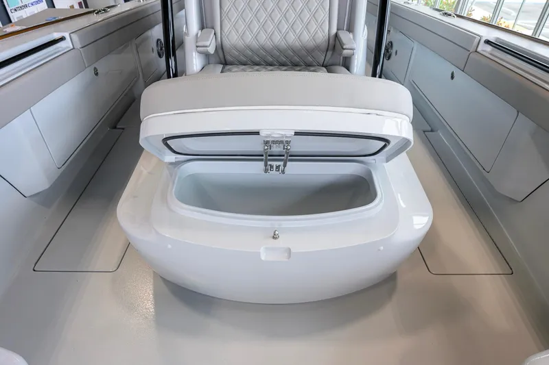 Slide: The Image of 2026 Valhalla Boatworks V-37 interior with open storage compartment and cushioned seating. - 14