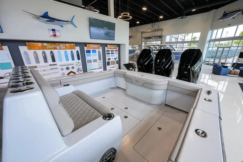 Slide: The Image of 2026 Valhalla Boatworks V-37 interior with seating and outboard motors in showroom. - 31