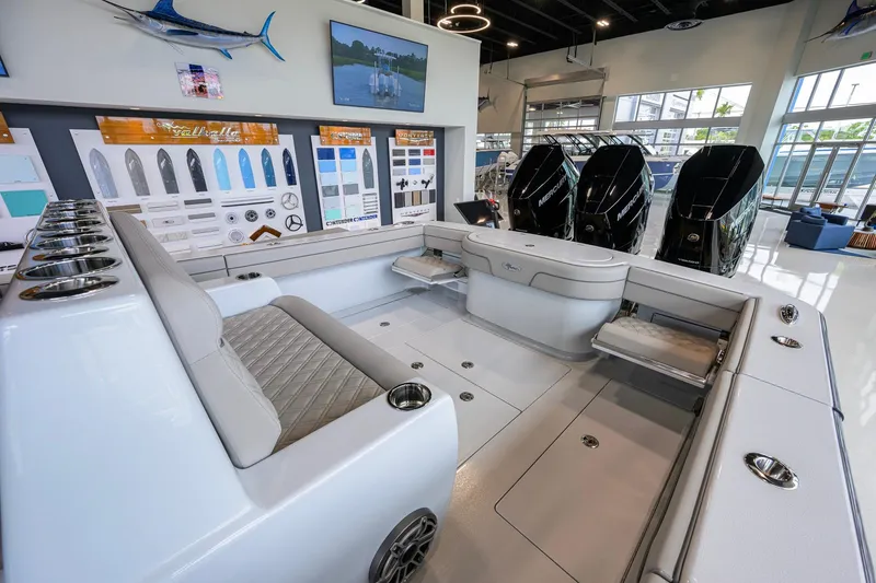Slide: The Image of Interior view of 2026 Valhalla Boatworks V-37, showcasing seating and engine area in showroom. - 34
