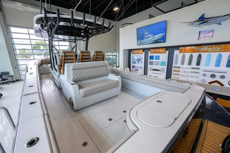 Slide: The Image of 2026 Valhalla Boatworks V-37 interior, showcasing luxury seating and modern design in showroom. - 39