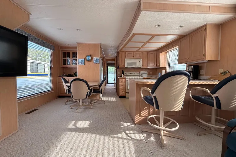 Slide: The Image of Spacious Sunstar 16x65 houseboat interior with kitchen, dining area, and modern amenities, year 2000. - 11