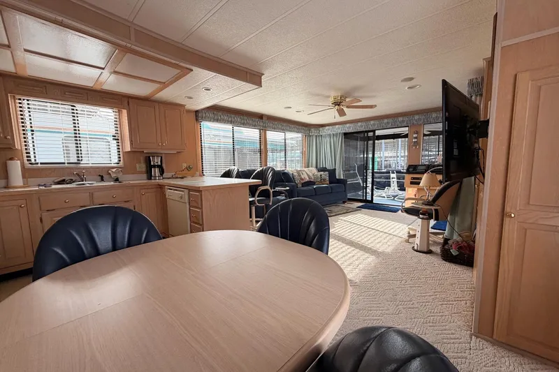 Slide: The Image of Interior of a 2000 Sunstar 16x65 houseboat with kitchen, dining, and living area. - 12