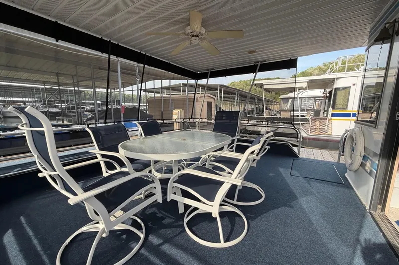 Slide: The Image of Spacious Sunstar 16x65 houseboat deck with table and chairs, year 2000 model. - 2