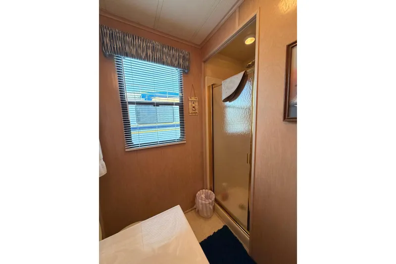 Slide: The Image of Bathroom interior of 2000 Sunstar 16x65 houseboat with shower and window blinds. - 20