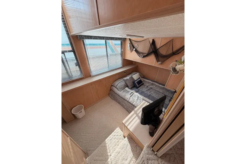 Slide: The Image of Cozy bedroom in 2000 Sunstar 16x65 houseboat with nautical decor and natural light. - 22