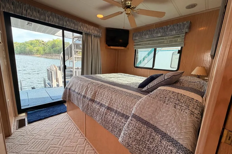 Slide: The Image of Cozy bedroom in 2000 Sunstar 16x65 houseboat with lake view and modern decor. - 28