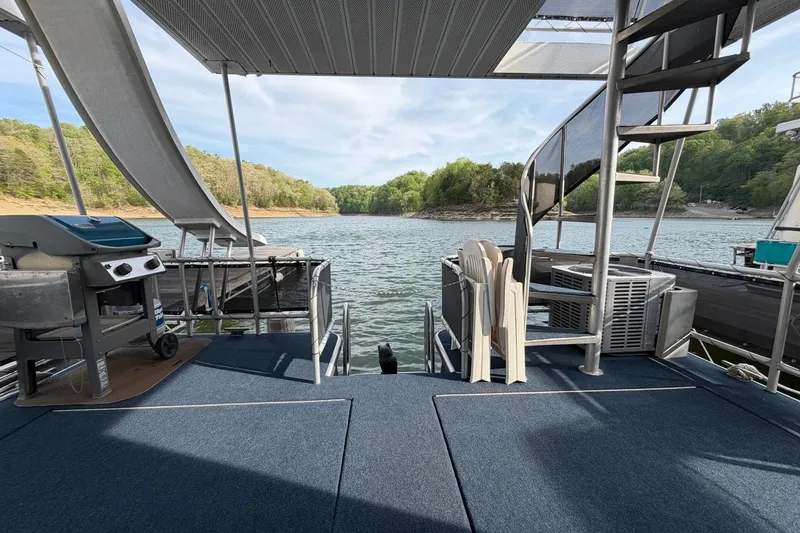 Slide: The Image of Houseboat deck with spiral staircase, grill, and lake view; Sunstar 16x65, 2000 model. - 33