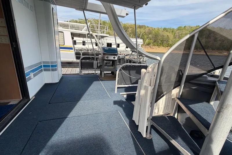Slide: The Image of Houseboat deck with blue carpet, grill, and stairs; Sunstar 16x65, 2000 model. - 35