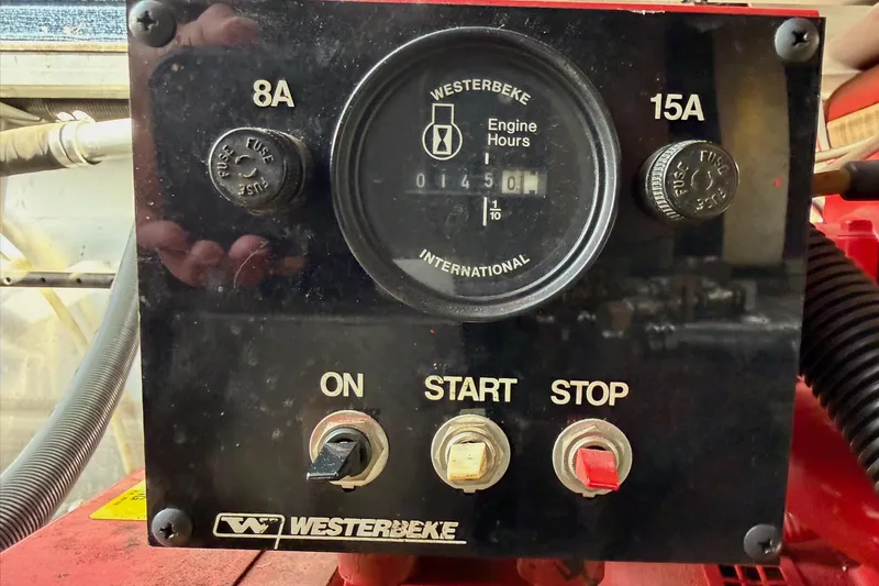 Slide: The Image of Control panel of a Westerbeke engine with switches and hour meter, Sunstar 16x65, 2000 model. - 42