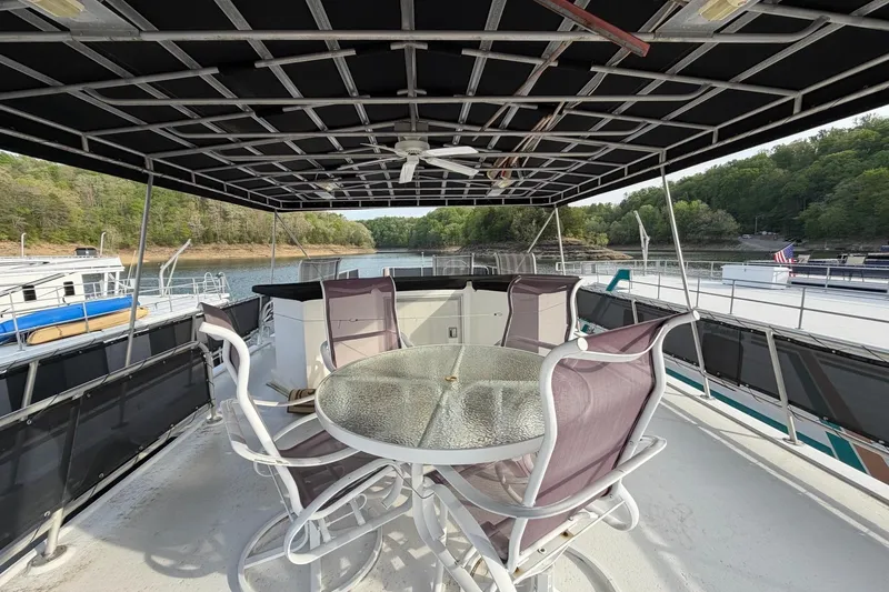 Slide: The Image of Upper deck of 2000 Sunstar 16x65 houseboat with seating and scenic lake view. - 46