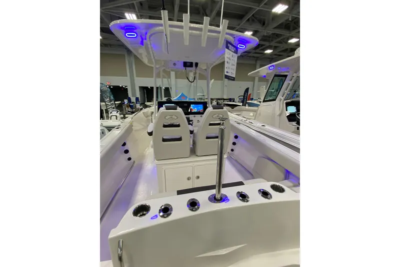 Slide: The Image of 2024 Sailfish 242 CC boat interior with modern seating and blue LED lighting. - 11