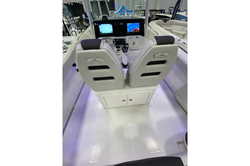 Slide: The Image of 2024 Sailfish 242 CC boat interior with dual helm seats and modern dashboard. - 13