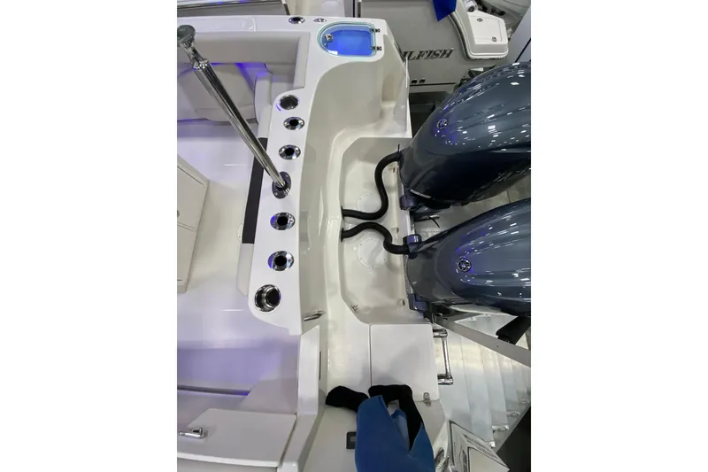 Slide: The Image of 2024 Sailfish 242 CC boat with dual outboard motors and rod holders. - 14