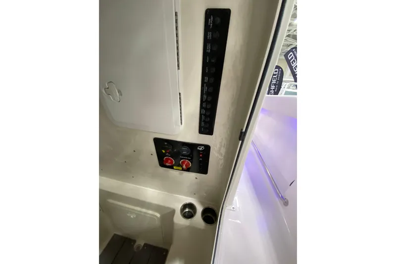 Slide: The Image of 2024 Sailfish 242 CC boat interior control panel and storage compartment. - 18