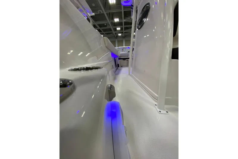 Slide: The Image of 2024 Sailfish 242 CC boat interior with blue LED lighting and sleek design. - 5