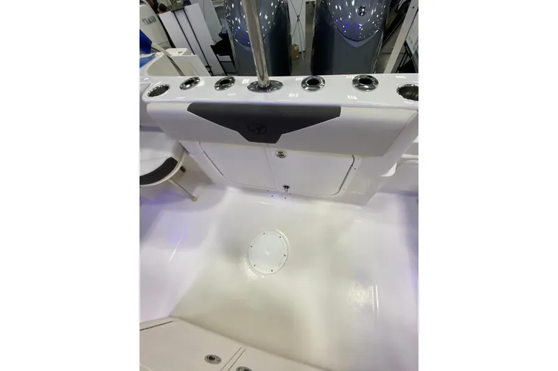Slide: The Image of 2024 Sailfish 242 CC boat interior with rod holders and storage compartments. - 6