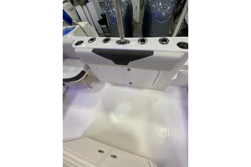 Slide: The Image of 2024 Sailfish 242 CC boat interior with rod holders and storage compartments. - 7