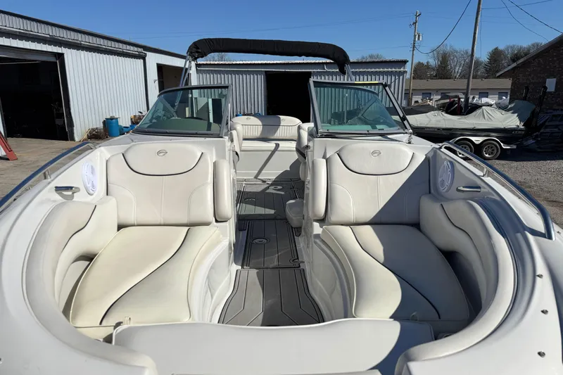Slide: The Image of 2007 Crownline 240 EX boat with spacious white seating and open deck layout. - 10