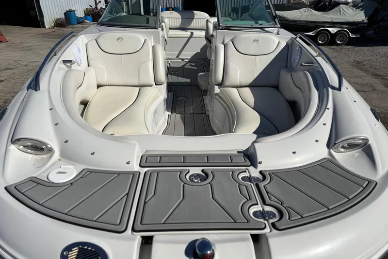 Slide: The Image of 2007 Crownline 240 EX boat interior with white seating and gray flooring. - 11