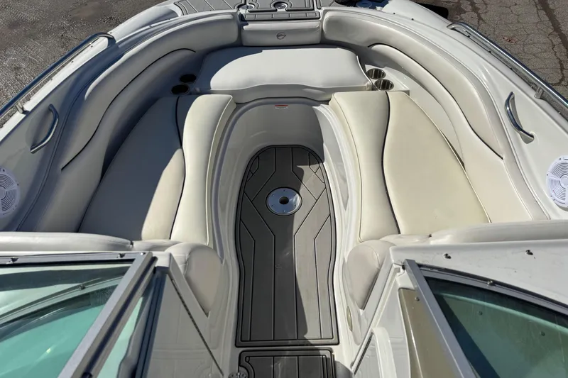 Slide: The Image of Interior view of a 2007 Crownline 240 EX boat with white seating and cup holders. - 12