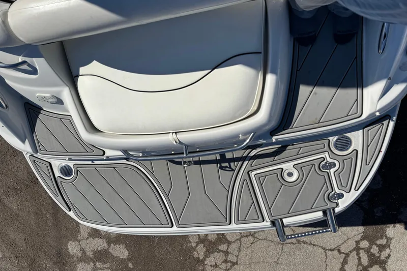 Slide: The Image of 2007 Crownline 240 EX boat deck with gray non-slip surface and white seating. - 13