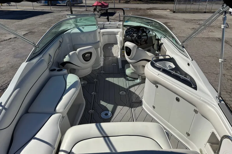 Slide: The Image of 2007 Crownline 240 EX boat interior with white seating and modern dashboard. - 14