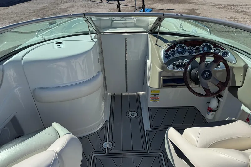 Slide: The Image of 2007 Crownline 240 EX boat interior with steering wheel and dashboard controls. - 19