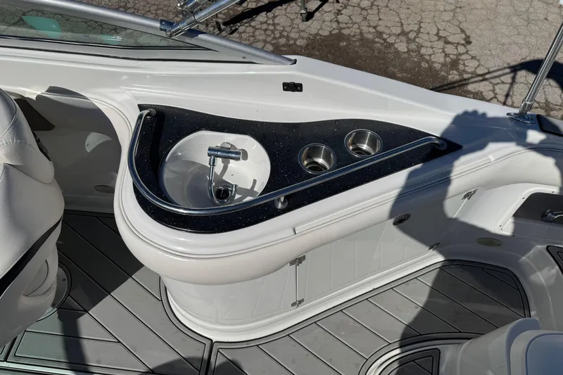 Slide: The Image of 2007 Crownline 240 EX boat interior with sink and cup holders. - 21