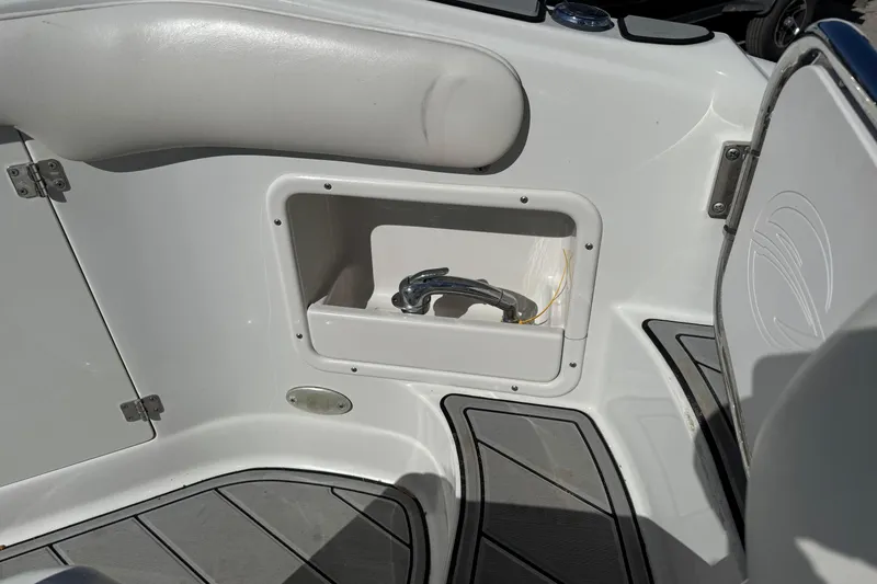 Slide: The Image of 2007 Crownline 240 EX boat interior with storage compartment and seating. - 22