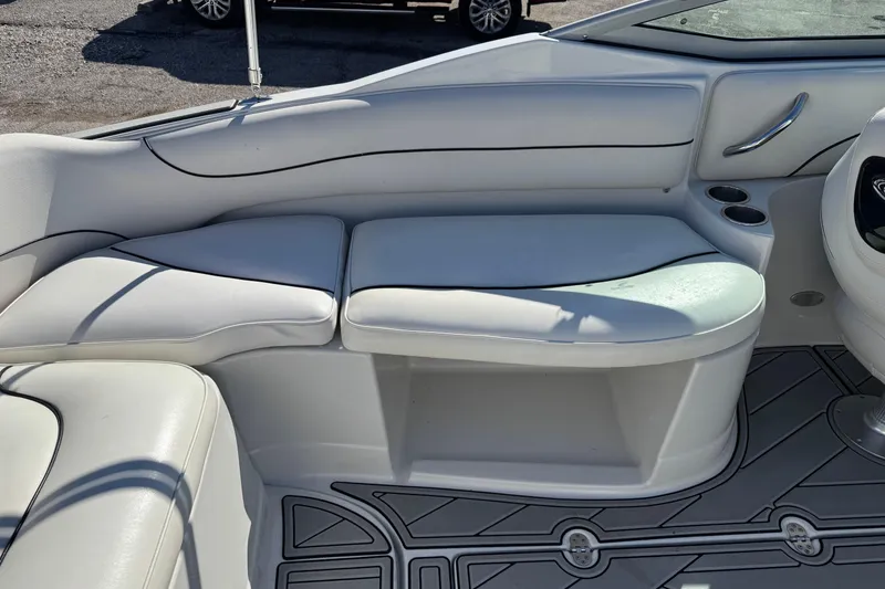 Slide: The Image of 2007 Crownline 240 EX boat interior with white seating and cup holders. - 23