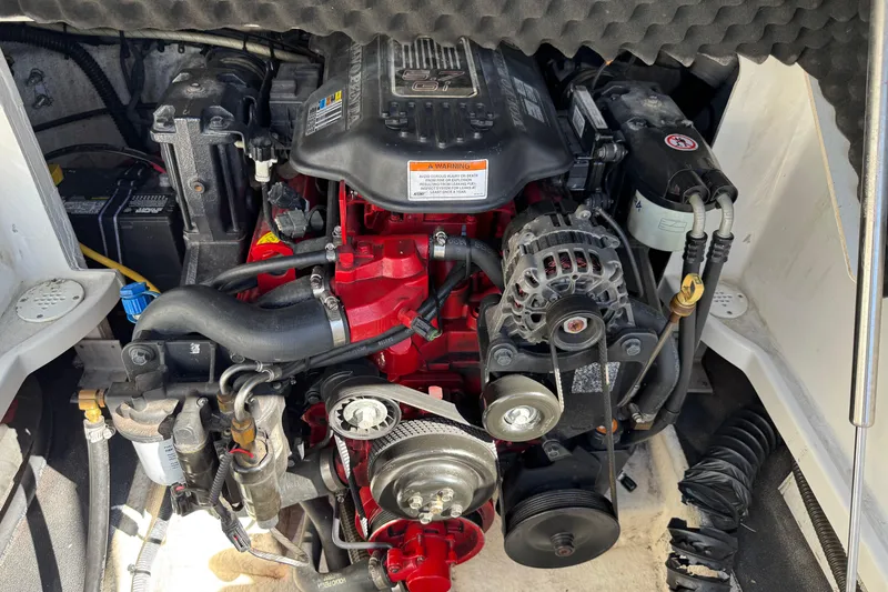 Slide: The Image of Engine compartment of a 2007 Crownline 240 EX boat, showcasing detailed mechanical components. - 28