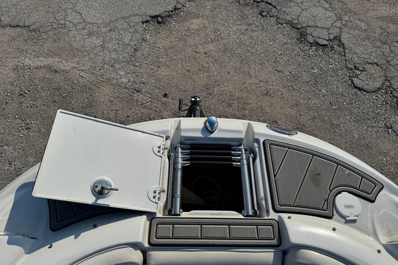 Slide: The Image of 2007 Crownline 240 EX boat with open storage compartment on deck. - 31